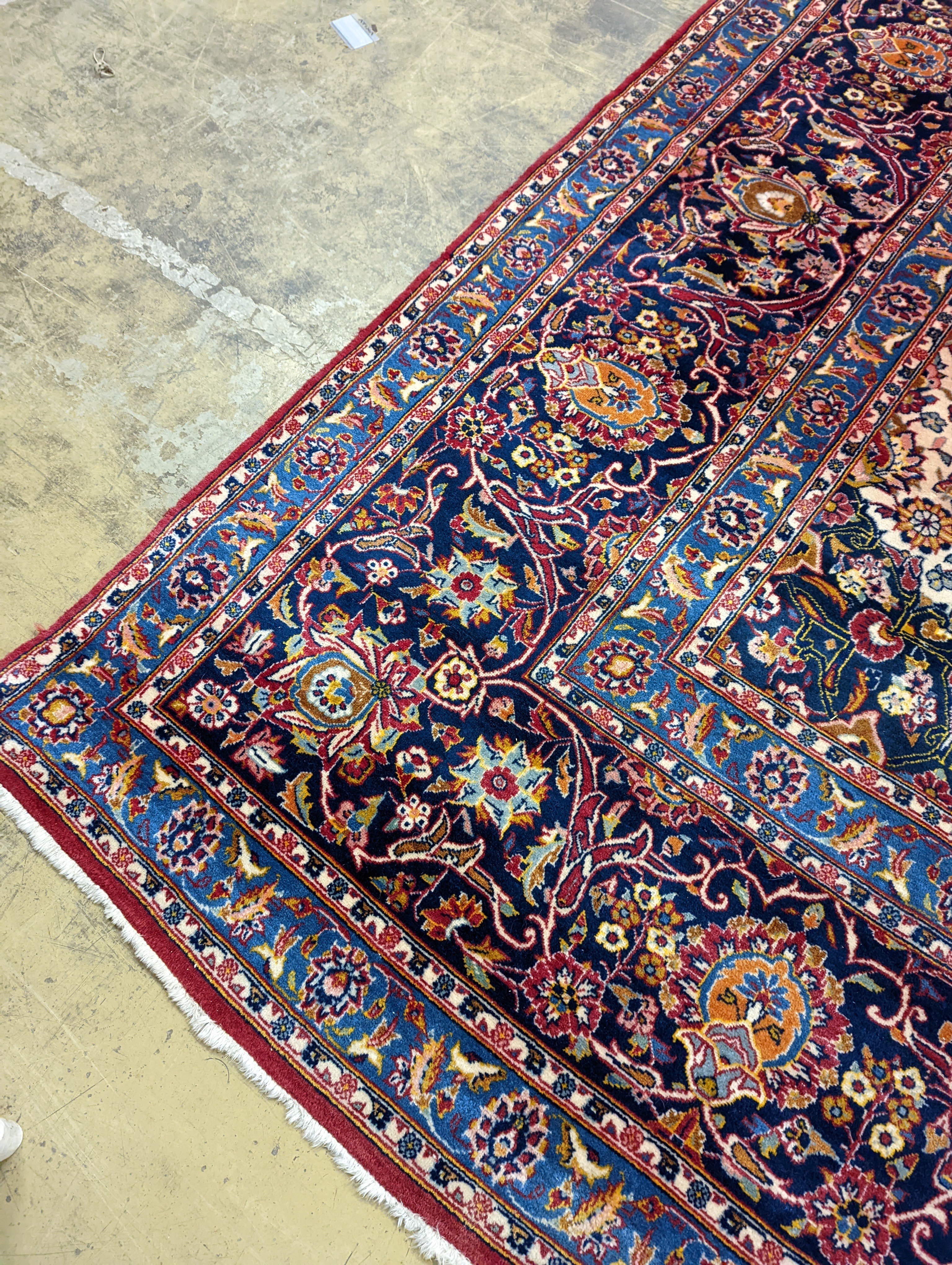 A large Tabriz red ground floral carpet, 540 x 350cm